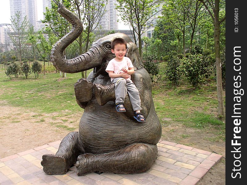 A boy sitting on an elephant