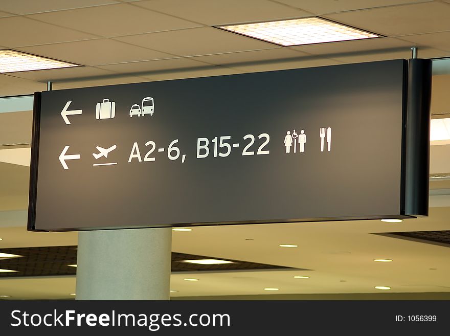 Airport sign directing to departure gates, baggage, ground transportation, etc