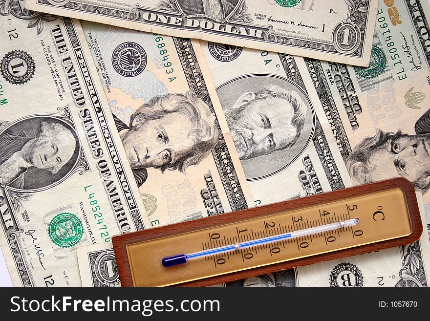 Dollars and thermometer in closeup, stability