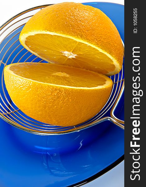 Half of orange on a blue plate