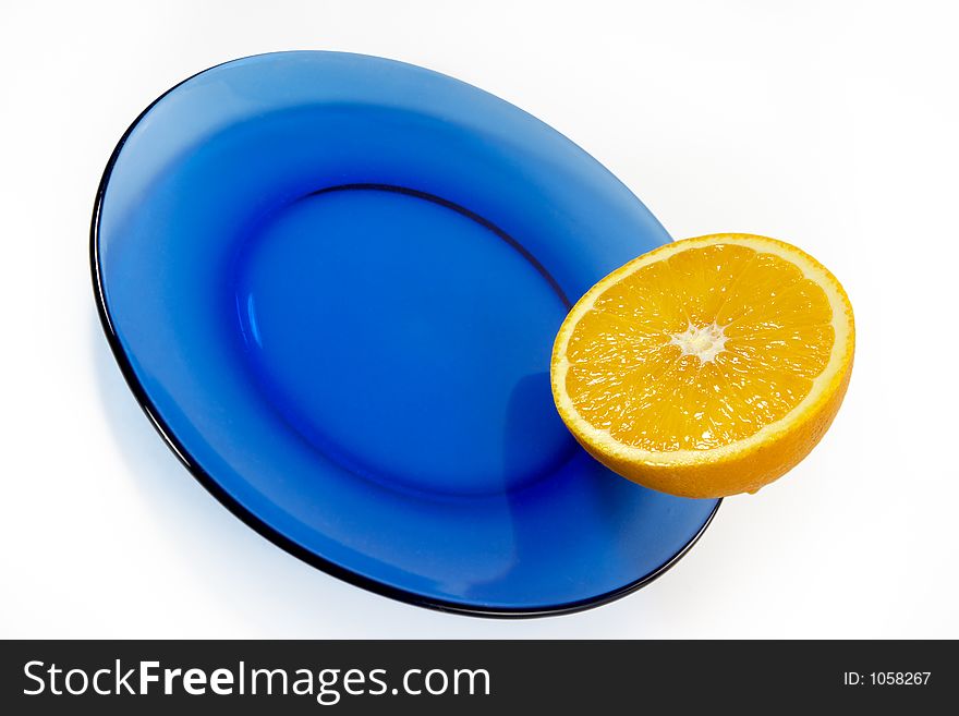 Half of orange on a blue plate