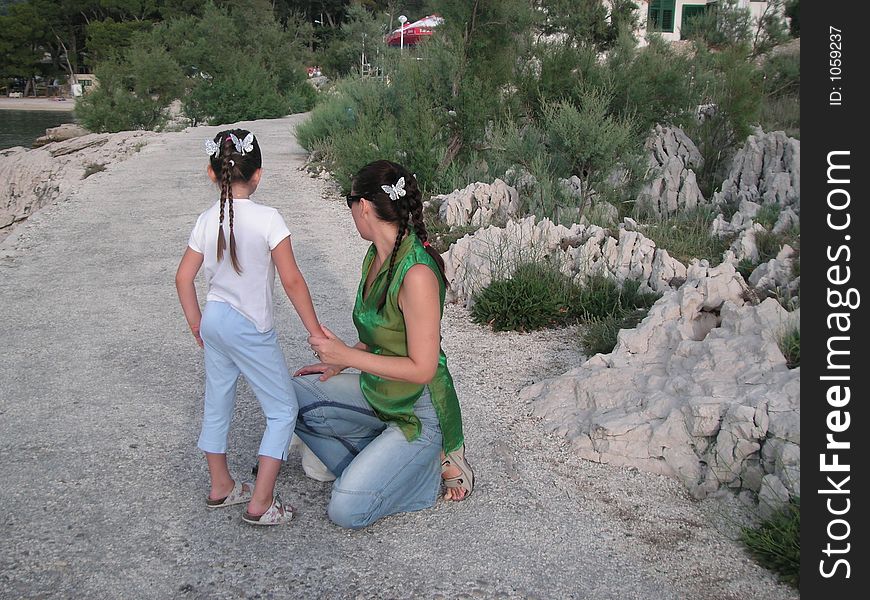 A little girl and her mum with silver butterflies in the hair. Photo taken im Makarska, a summer holiday resort in Croatia.