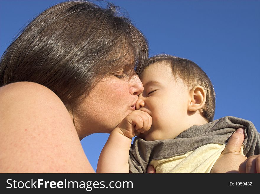 Mother and son over blue sky