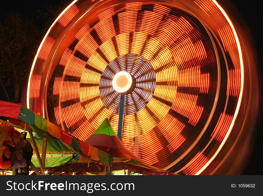 Carnval ferris wheel in motion at night. Carnval ferris wheel in motion at night.