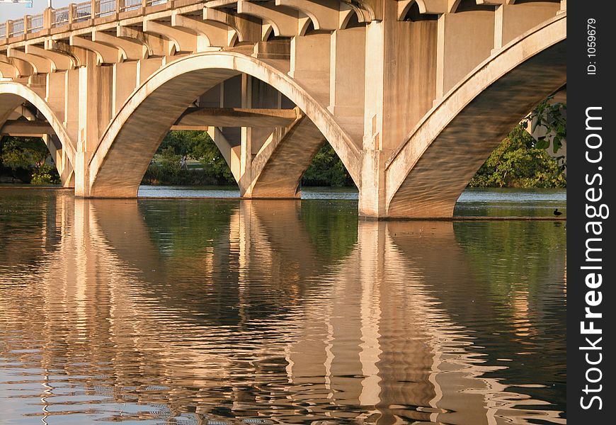 This bridge devides Austin into South Austin and North Austin. It was taken at sunset. You can see its majestic reflection on the water. This bridge devides Austin into South Austin and North Austin. It was taken at sunset. You can see its majestic reflection on the water.