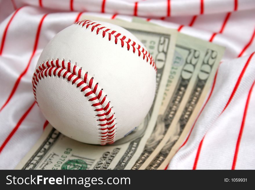 Baseball and dollars in closeup. Baseball and dollars in closeup