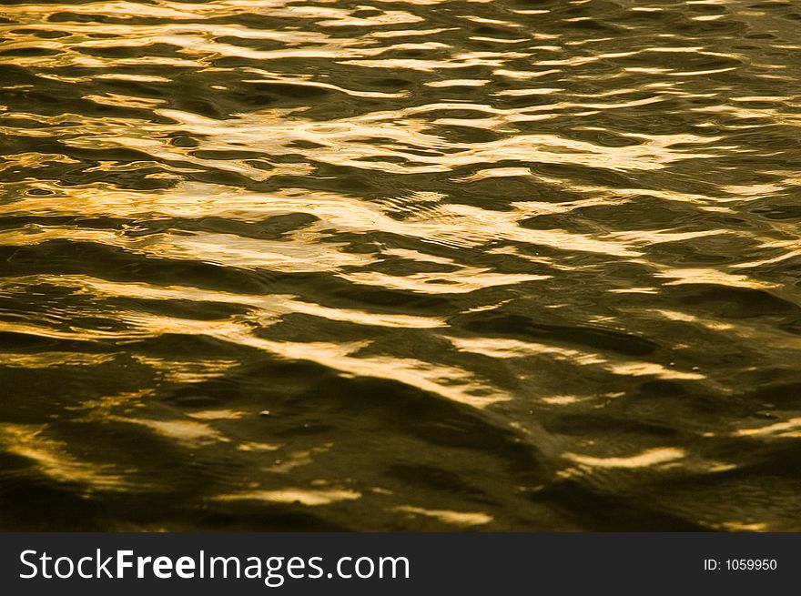 Ripples from the susnset tides create a beatiful pattern of reflections. Ripples from the susnset tides create a beatiful pattern of reflections