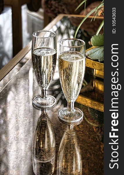 Champagne glasses sparkling on marble table