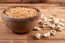 Raw Corn Seeds In Wooden Bowl And Popped Popcorn On Table Royalty Free Stock Image Raw Corn Seeds In Wooden Bowl And Popped Popcorn On Table Royalty Free Stock Image