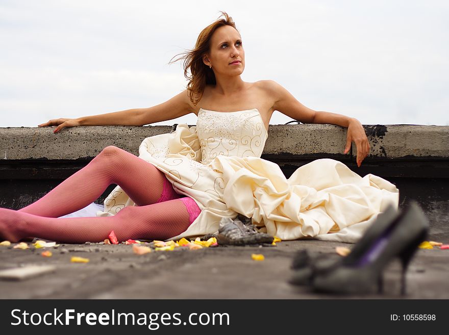 Woman in a wedding dress and in pink stockings. Woman in a wedding dress and in pink stockings