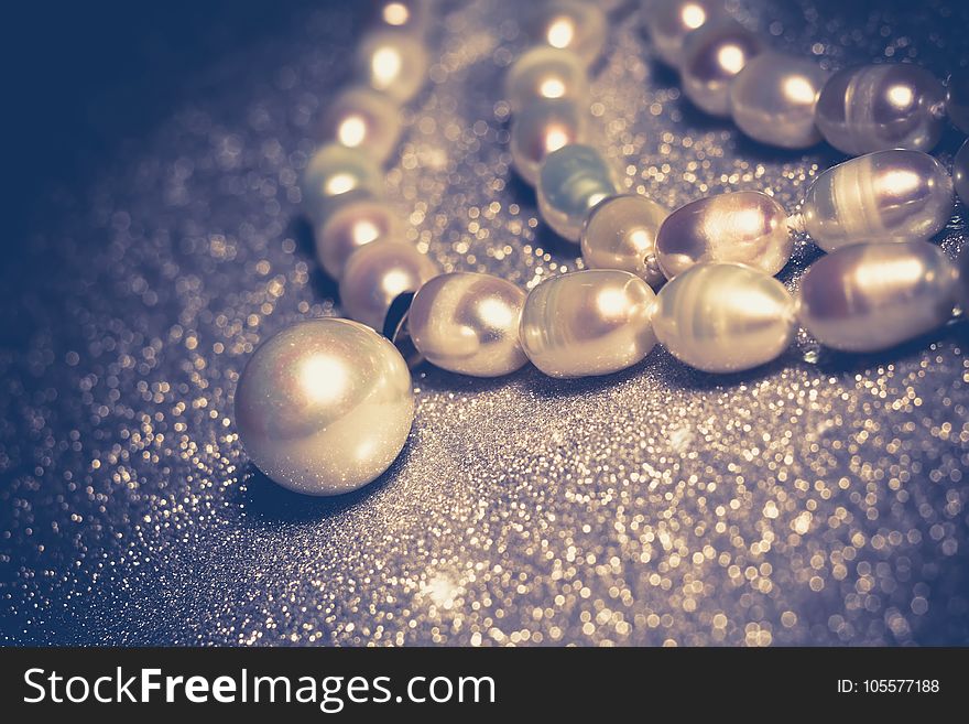 Natural white freshwater pearl necklace close up filtered background. Natural white freshwater pearl necklace close up filtered background.