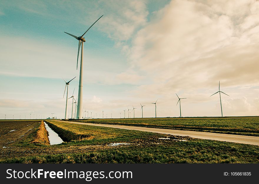 Windmill Energy On Green Grass Field