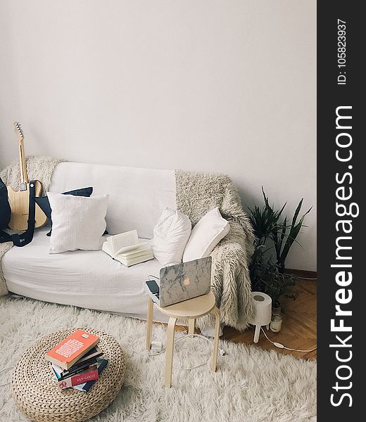 White And Black Laptop Computer On Brown Wooden Stool Near Pile Books