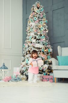 Emotional Little Girl. Happy New Year. Pleasure, Happiness And Delight From New Year`s Gifts. Royalty Free Stock Images