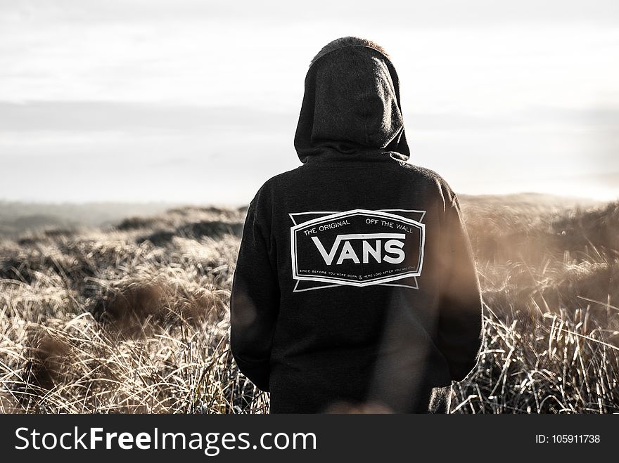 Photo Of Person Wearing Black Vans Hoodie