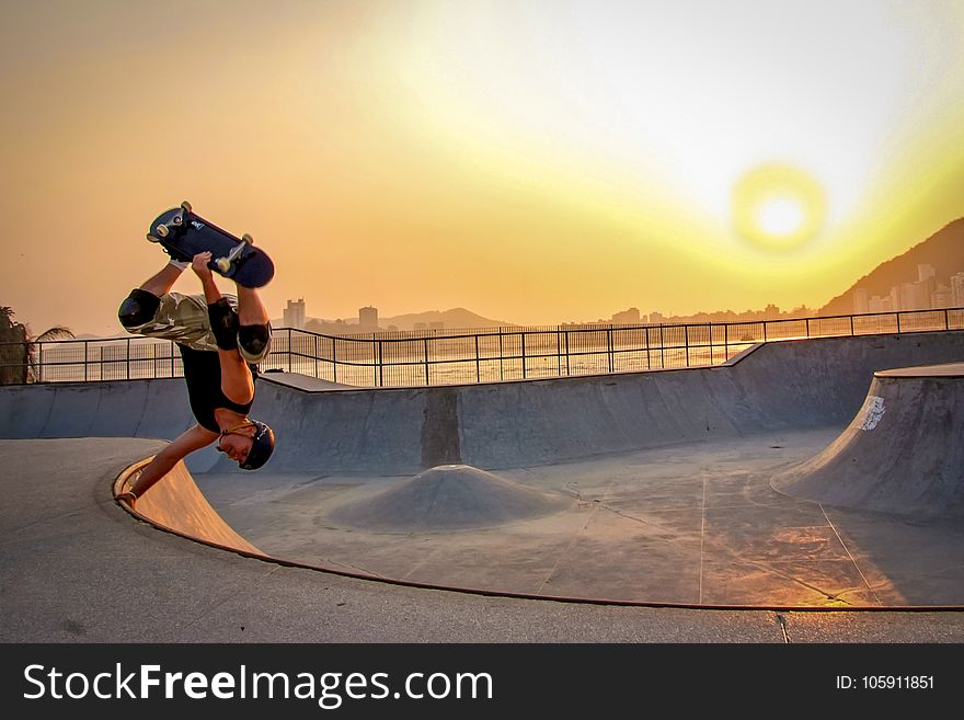 Man In Black Tank Top Skateboarding Wearing Helmet