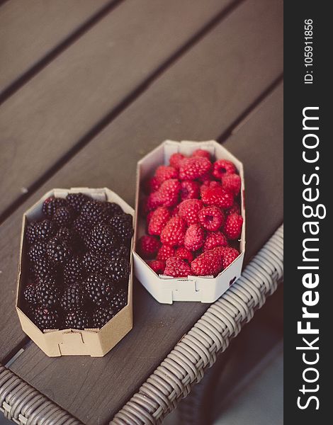 Raspberries And Blueberries On Top Of Table