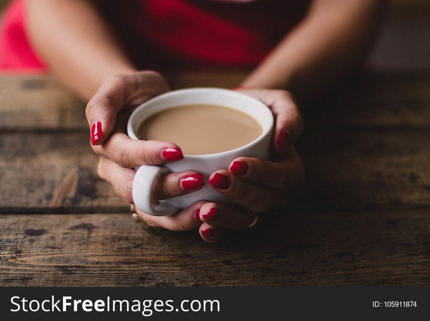 Women Holding Cup Of Coffee