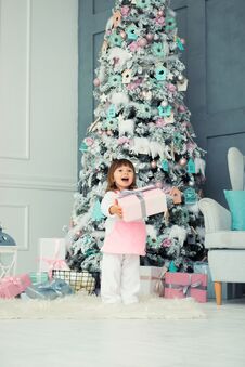 Emotional Little Girl. Happy New Year. Pleasure, Happiness And Delight From New Year`s Gifts. Royalty Free Stock Photo Emotional Little Girl. Happy New Year. Pleasure, Happiness And Delight From New Year`s Gifts. Royalty Free Stock Photo