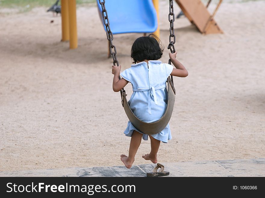 Bare-foot girl playing at beach playground. Bare-foot girl playing at beach playground