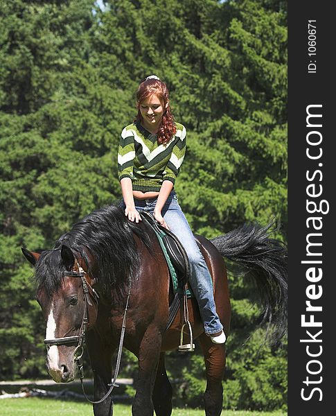 Girl on chestnut horse in summer day. Girl on chestnut horse in summer day