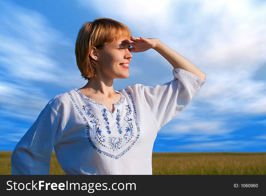 Beauty Girl In Field Under Clouds