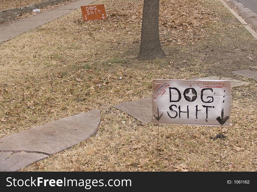 Handmade signs pointing to dog excrement. Handmade signs pointing to dog excrement