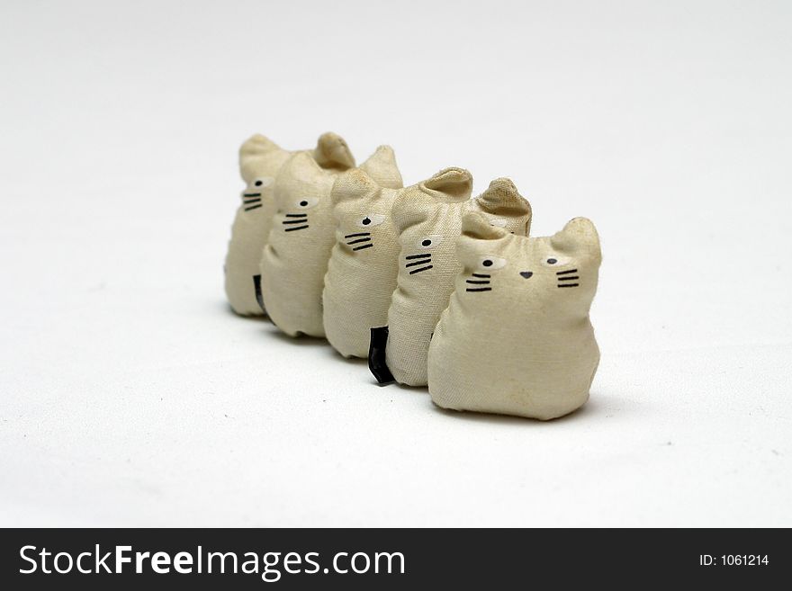 Bean Stuffed toy cats standing in a line - This is set of Five-Stones, a popular game that children in south east asia plays.