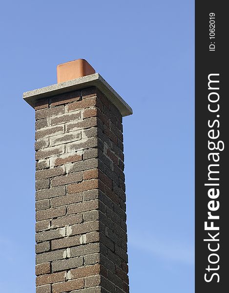 Multi Brown Brick Chimney Against a Blue Sky Background