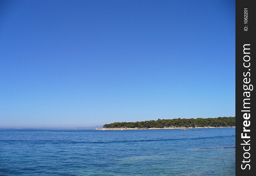 Blue sea with view of an island in the distance. Blue sea with view of an island in the distance