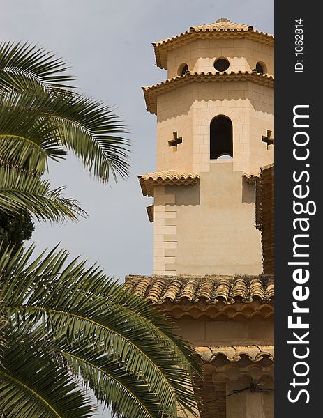 Church tower with palm tree to left