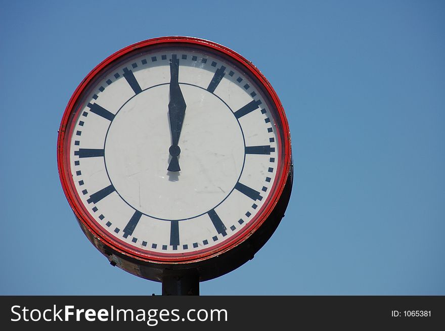 Big round red and white clock.