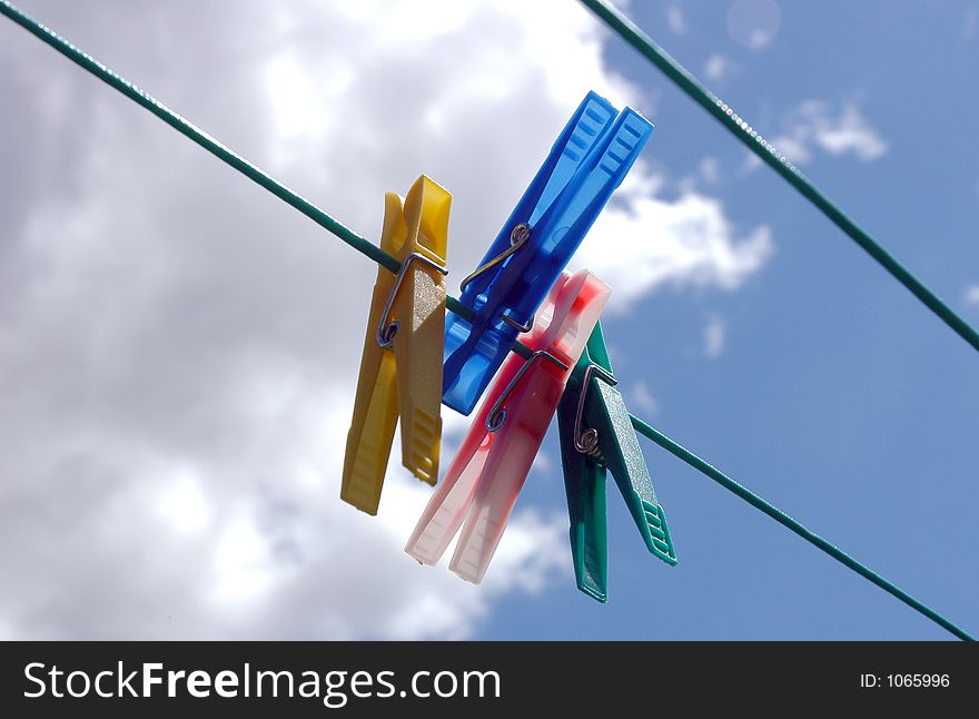 Pegs hanging on clothes line. Pegs hanging on clothes line