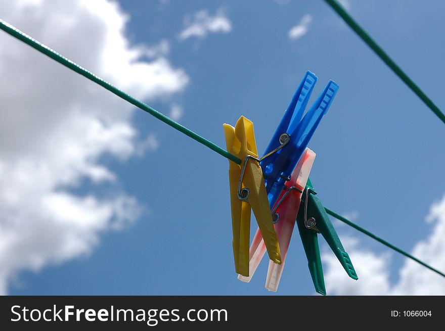 Pegs hanging on clothes line. Pegs hanging on clothes line