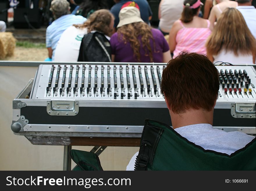 A man in front of a music equalizer at a concert. A man in front of a music equalizer at a concert