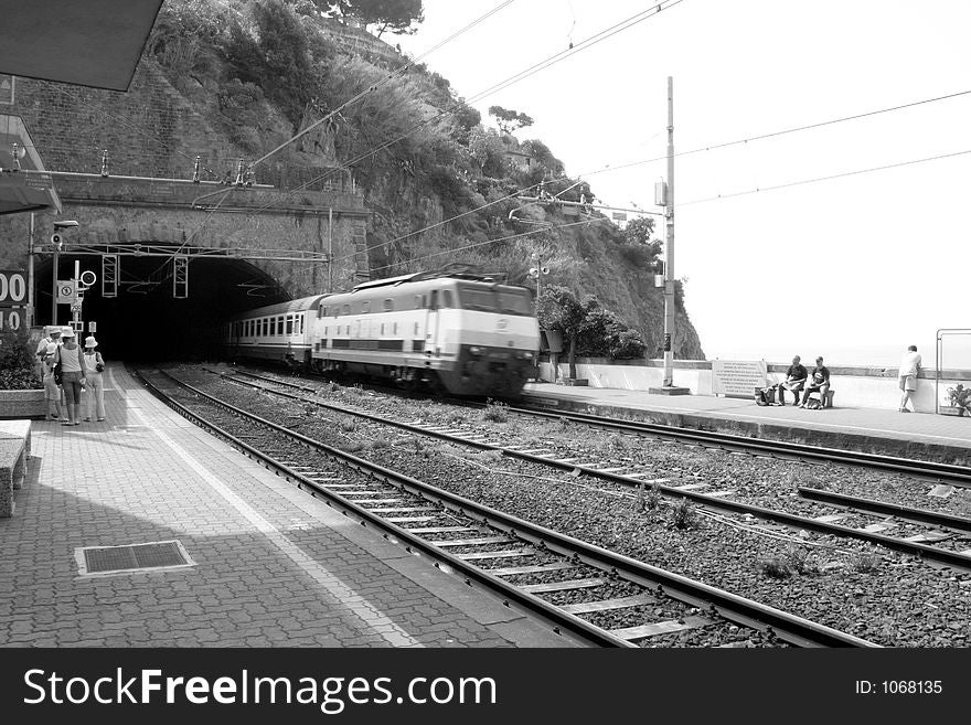 A train speeding through a station in the Cinque Terre on the coast in Italy. A train speeding through a station in the Cinque Terre on the coast in Italy.