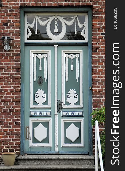 A richly ornamented door in a town in the southwestern part of Denmark. A richly ornamented door in a town in the southwestern part of Denmark.