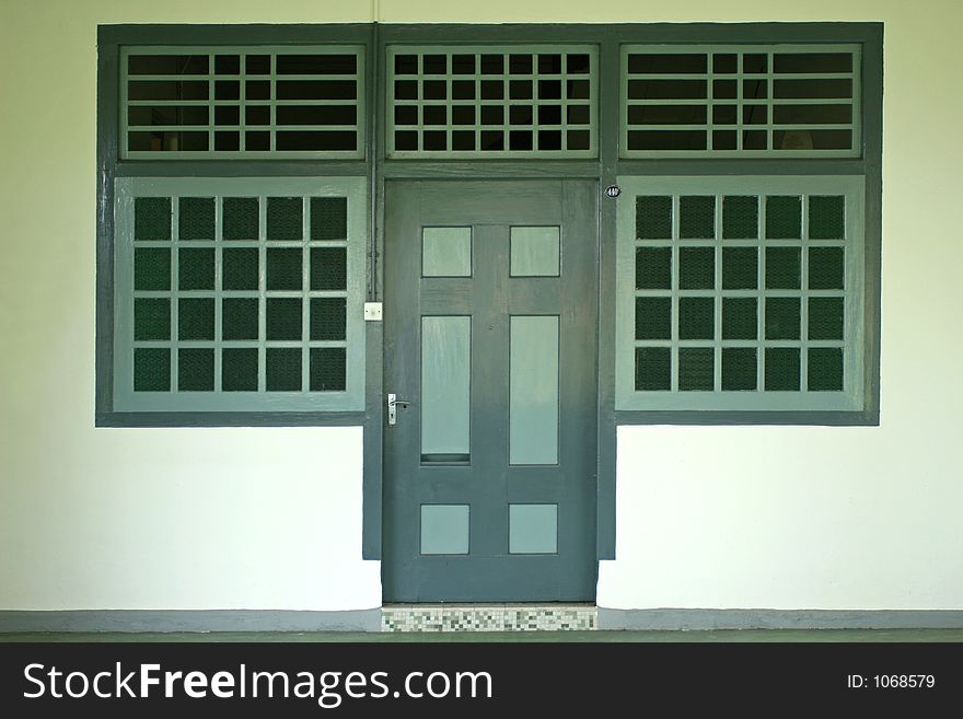 An old Chinese house with green door and windows. An old Chinese house with green door and windows