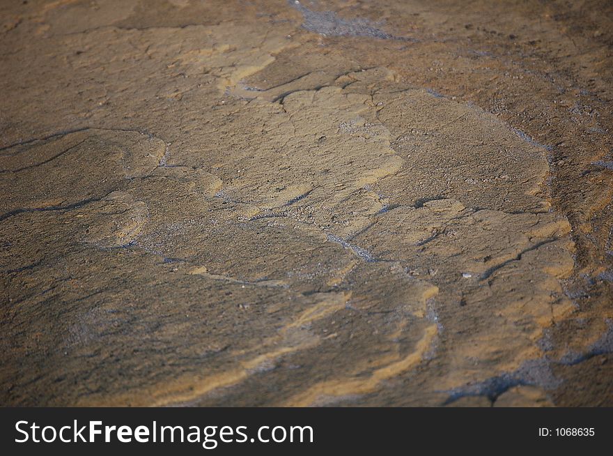 Forms of waves in stone, becoming sand. Forms of waves in stone, becoming sand