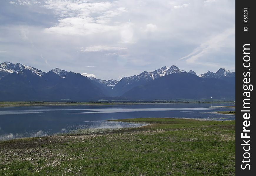 This image of the lake and marsh area with the mountains as a background was taken in western MT. This image of the lake and marsh area with the mountains as a background was taken in western MT.