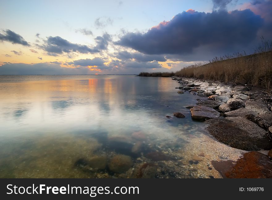 A rocky shore and sunset. A rocky shore and sunset