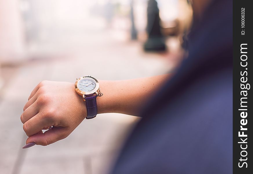 Person Wearing Round Gold Watch With Black Leather Strap