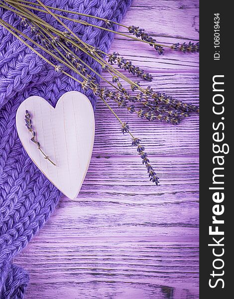 Happy Valentine`s Day. Wooden heart and lavender flowers on a lilac wooden background