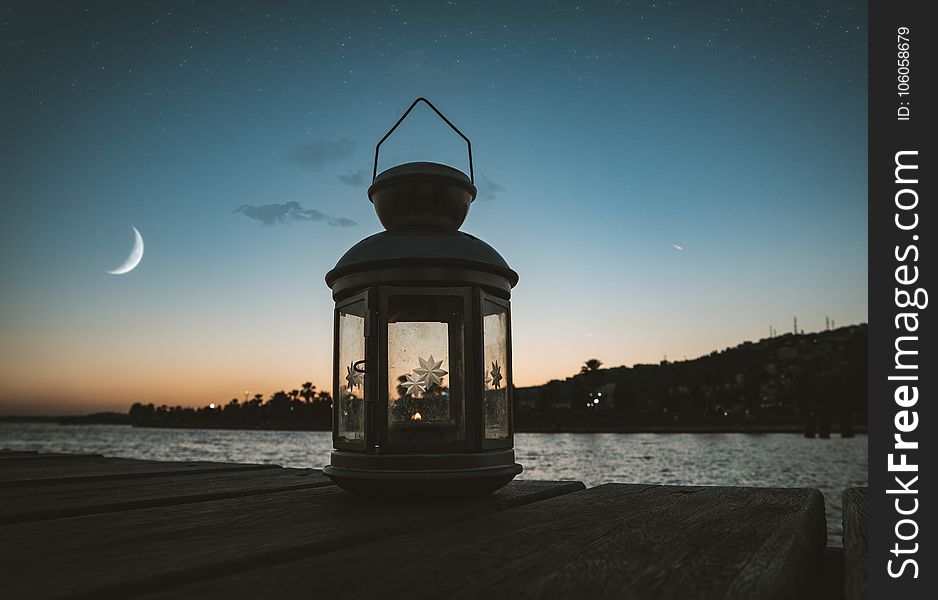 Gray Metal Candle Lantern On Boat Dock