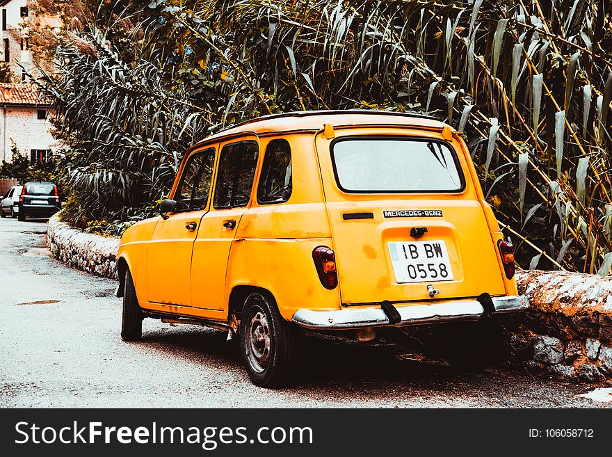 Classic Yellow Car on Side of Road at Day