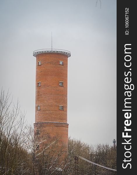 Vintage style red brick water tower of an old factory.