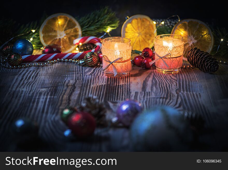 A Couple of Magic Christmas decorated Burning candles on wooden rustic background 1