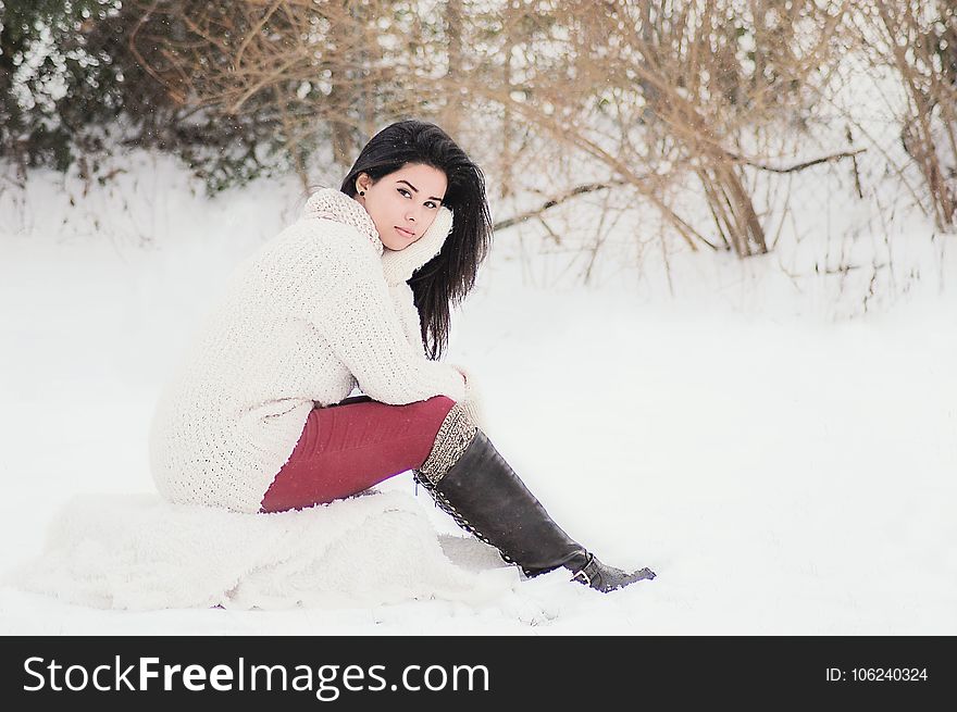 Woman In White Sweater Sitting Near Grass During Winter Season