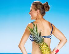 Free Young Woman In Bikini On Seacoast With Pineapple Stock Photography - 106278372