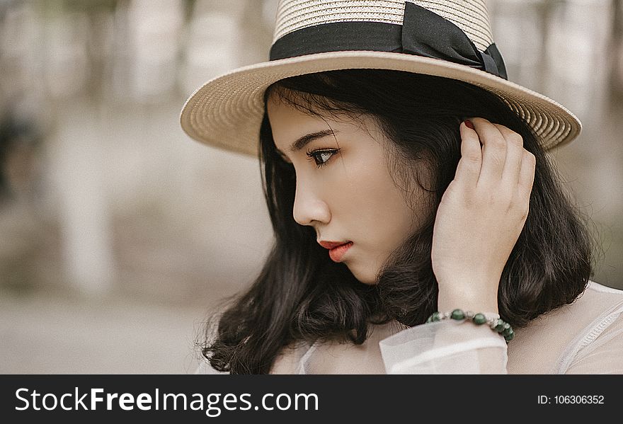 Shallow Focus Photography of Woman Wearing Brown Sun Hat